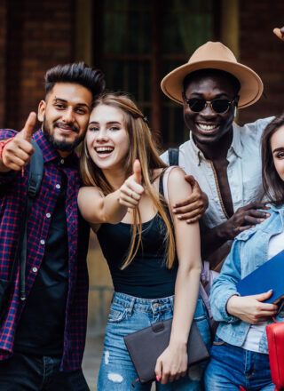 four-happy-students-near-university-campus