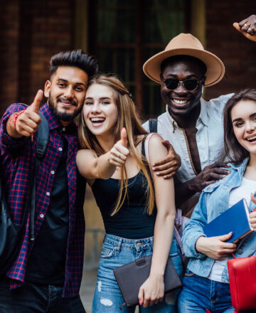 four-happy-students-near-university-campus