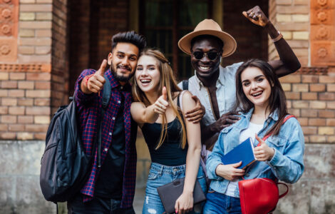 four-happy-students-near-university-campus