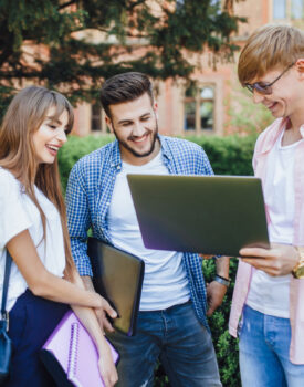 three-students-stylish-clothes-look-laptop-laugh-university-campus