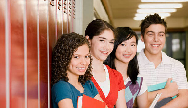 High-school students standing in front of lockers
